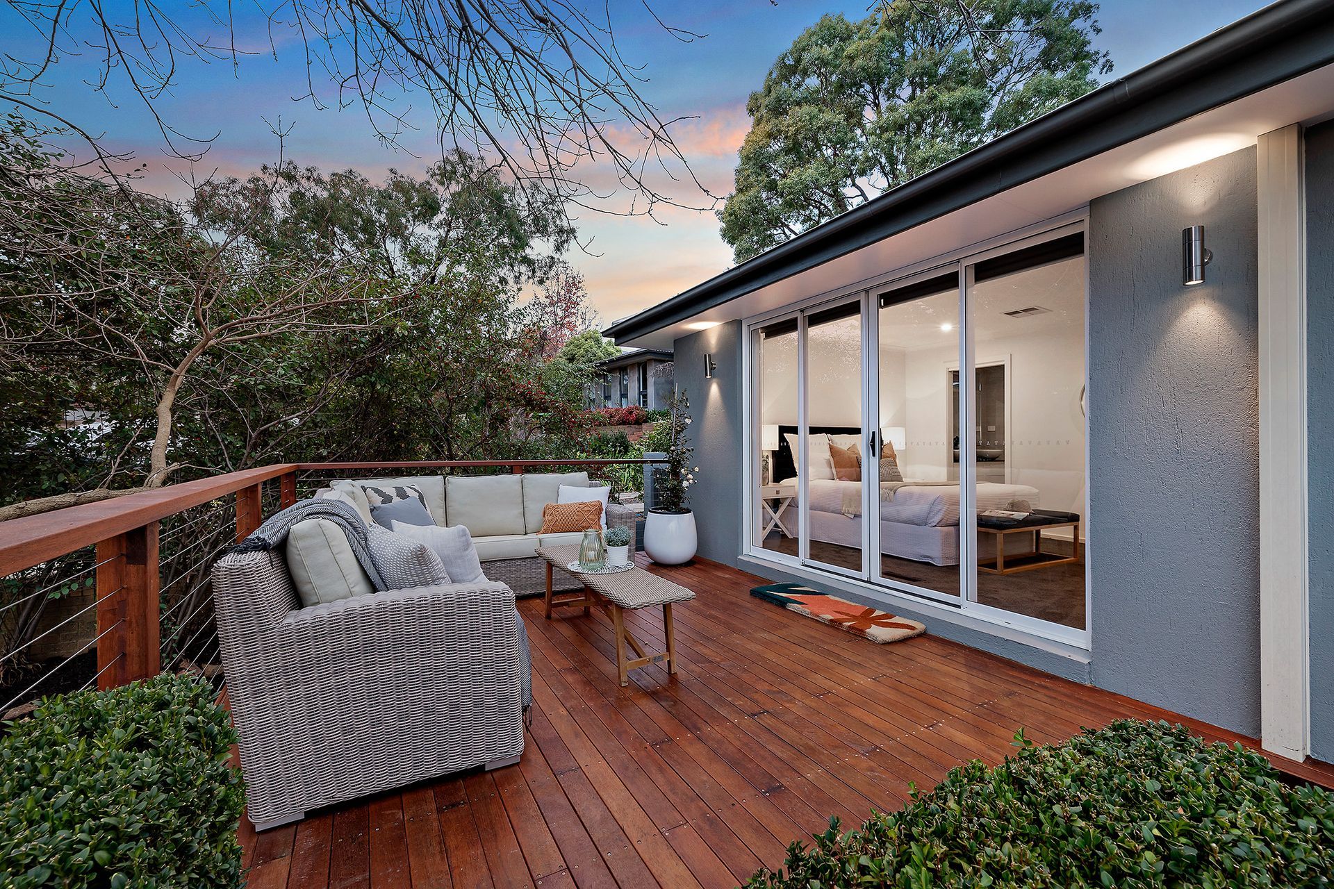 Kitchen with granite countertops, black sink, and a view through a doorway to a bathroom with a window.
