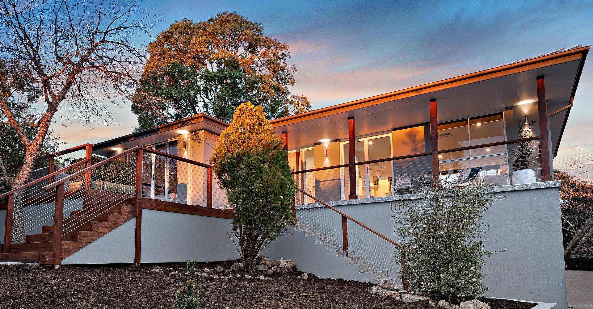 Living room with sliding door to deck, gray sofa, chair, and coffee table.