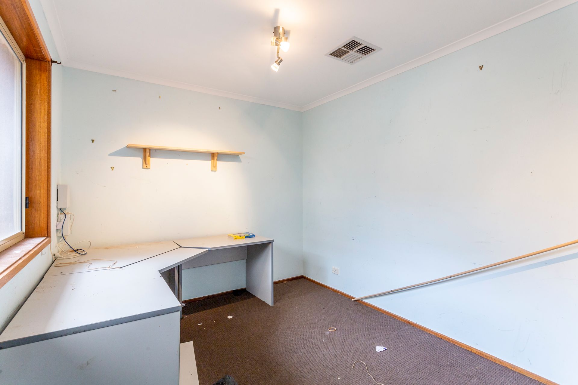 Kitchen with sliding glass door, countertop, microwave. Mint green walls, beige countertop.