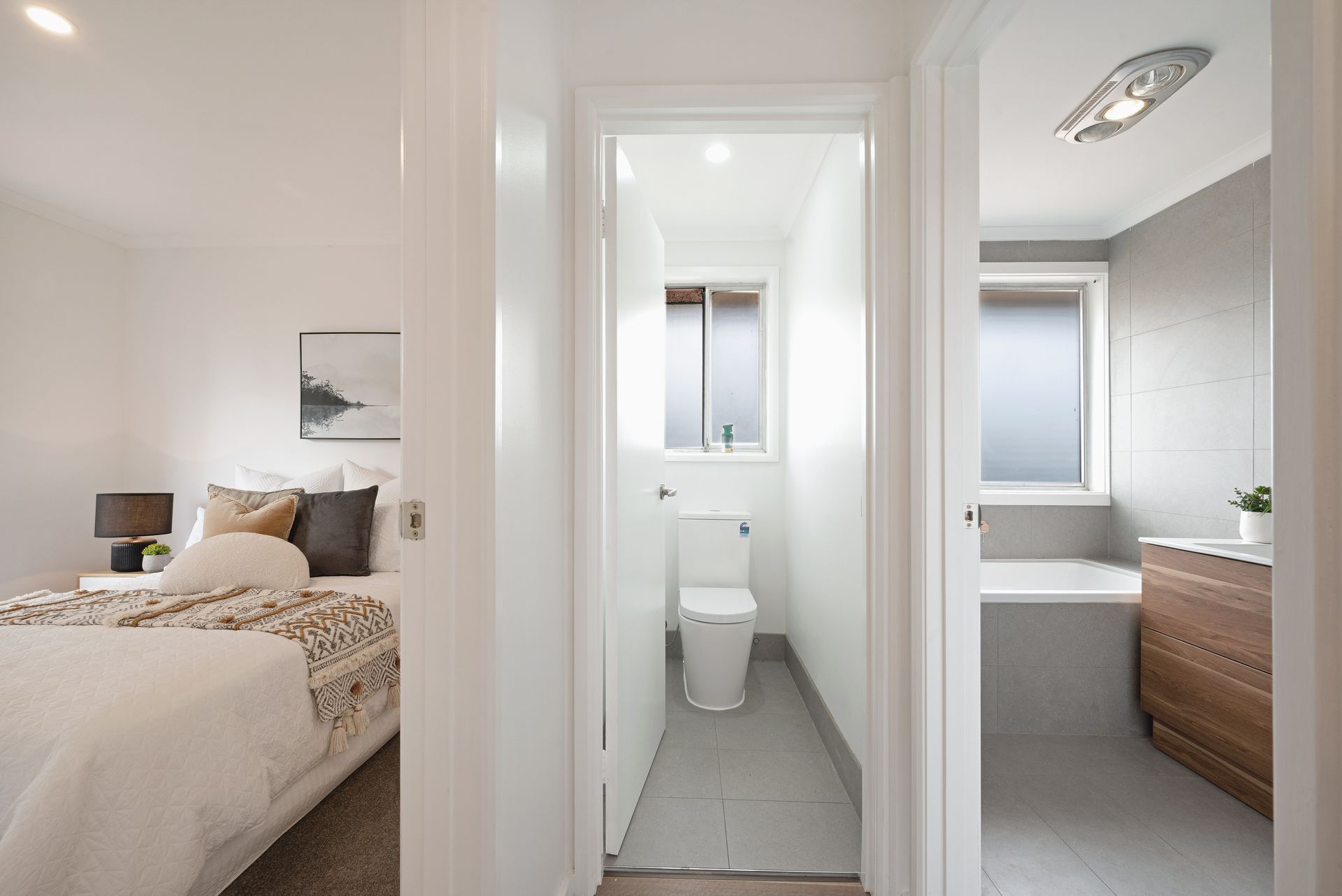 Dining room with table, chairs, art, shelves, plants, and natural light.
