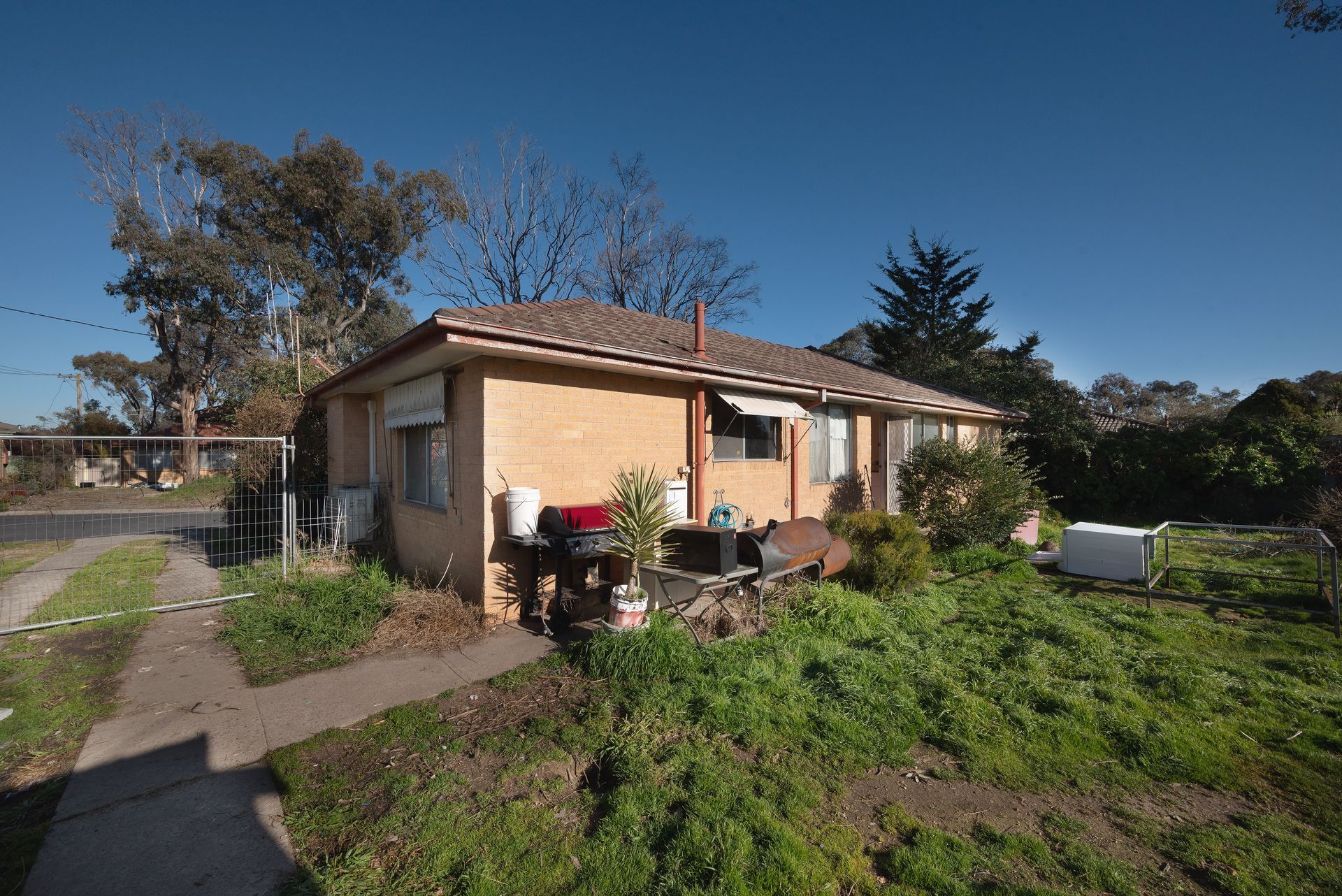 Living room filled with moving boxes and furniture, preparing for relocation.