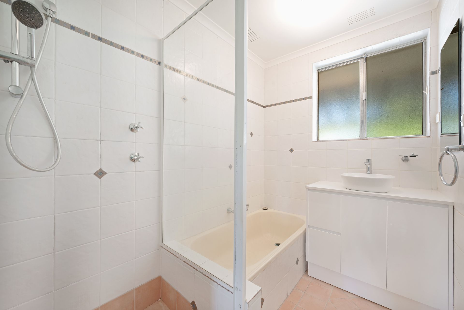 White interior room with tall storage cabinets and a screen door to the outside.