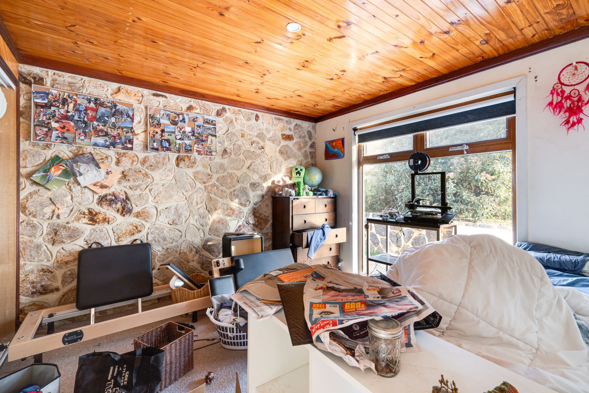 Interior entryway with open wooden door, tiled floor, carpeted living area, and a view of a tree outside.