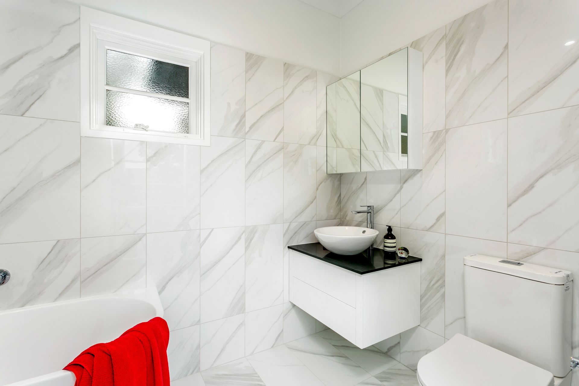 Dining room with wooden furniture, sliding door to balcony, and entrance to another room.