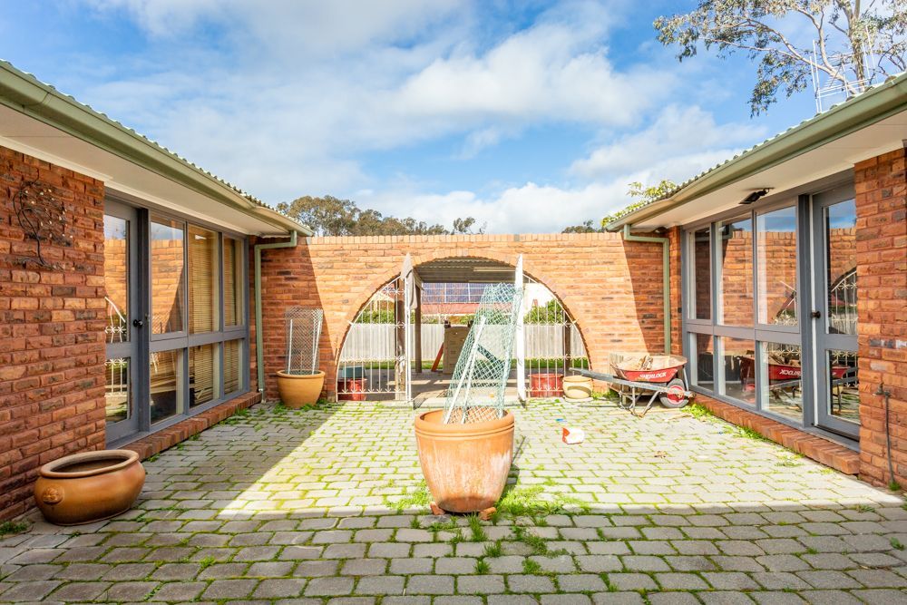 Dining room with table, chairs, windows, and skylights. Interior, natural light, and view of the backyard.