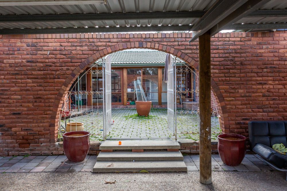 Dining room with table, chairs, windows, and skylights. Interior, natural light, and view of the backyard.