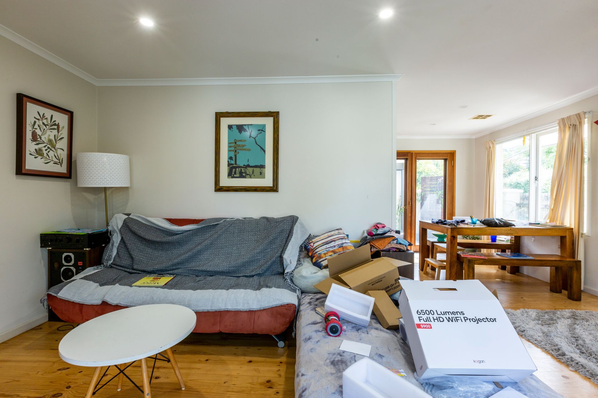 Bathroom with tub, shower, and vanity. Pale blue tiled walls, window, and neutral tones.