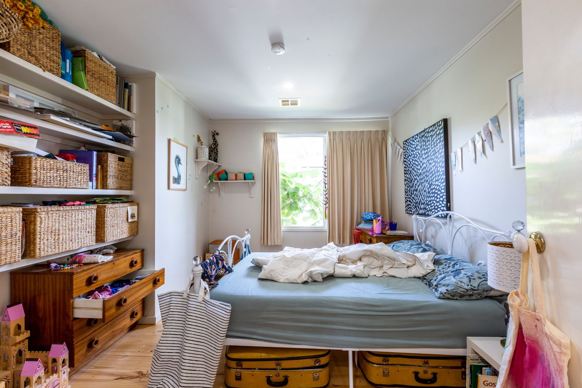 Covered patio with outdoor furniture, next to a brick home.
