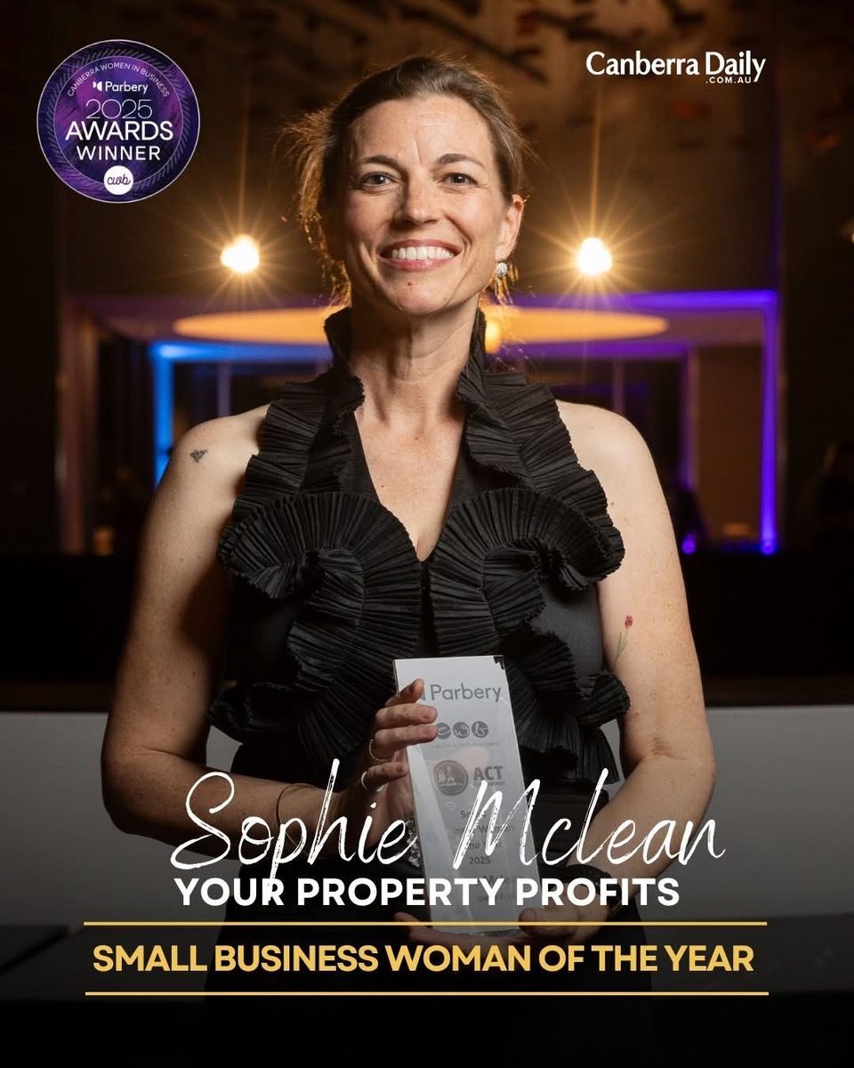 Woman with fair skin smiling, wearing a striped shirt and silver jewelry.