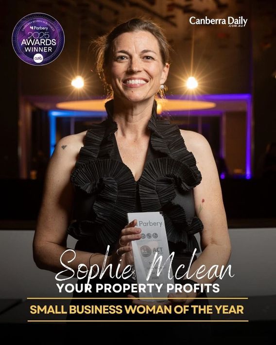 Woman with fair skin smiling, wearing a striped shirt and silver jewelry.
