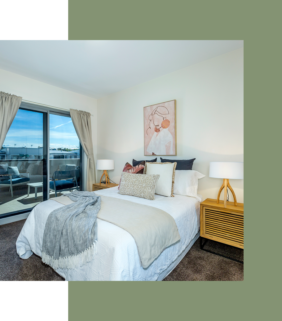Bedroom with a bed, nightstands, sliding glass door to a balcony. Beige walls, neutral-toned bedding, light blue outdoor view.