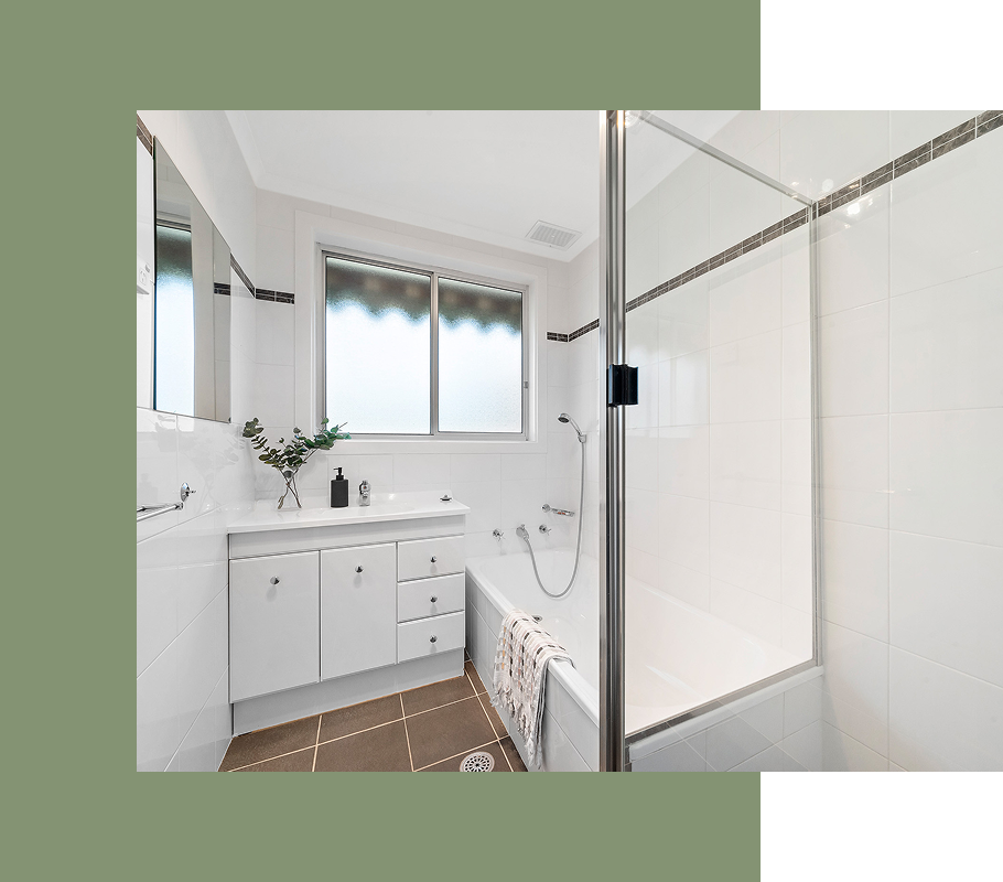 White bathroom with a tub, shower, sink, and window.