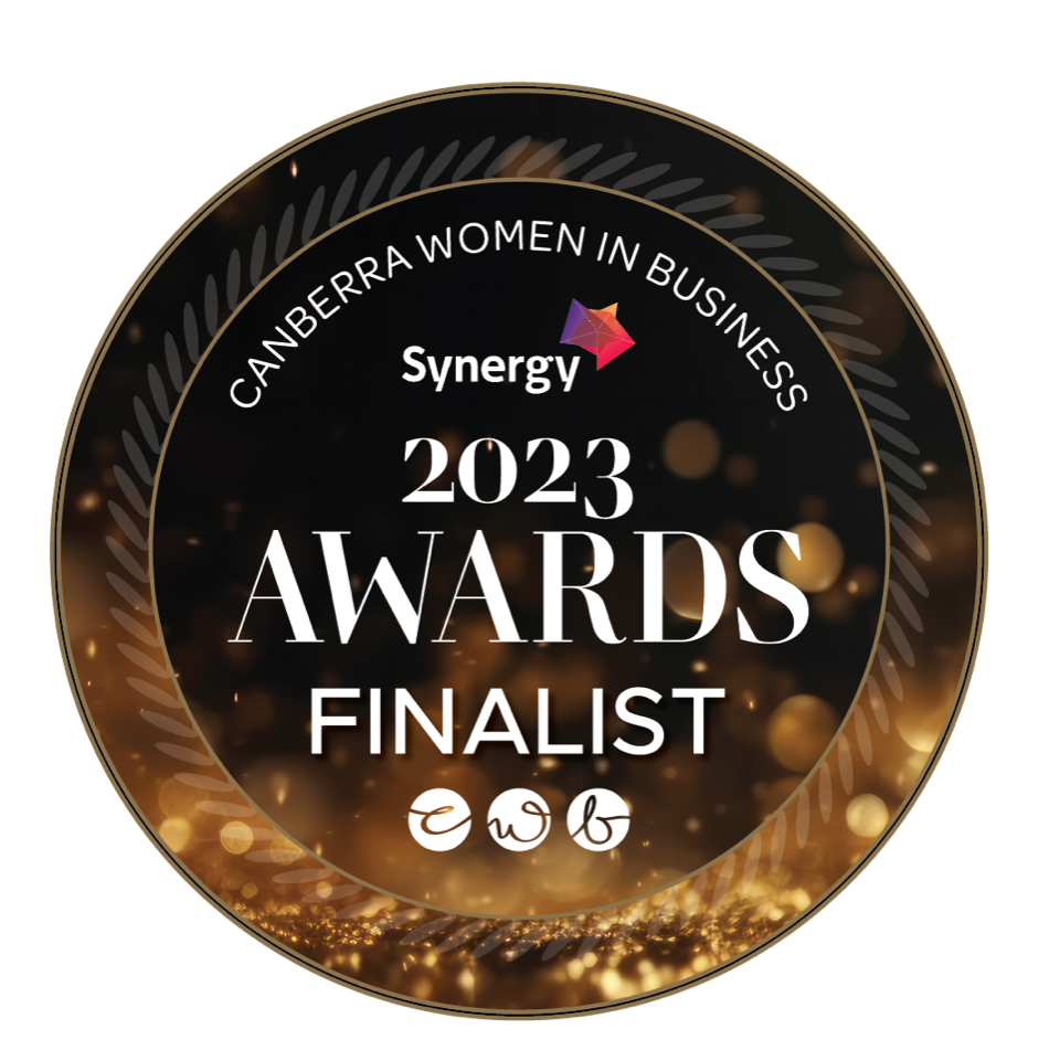 Canberra Women in Business 2023 Awards Finalist badge. Black and gold with Synergy logo and CWIB initials.