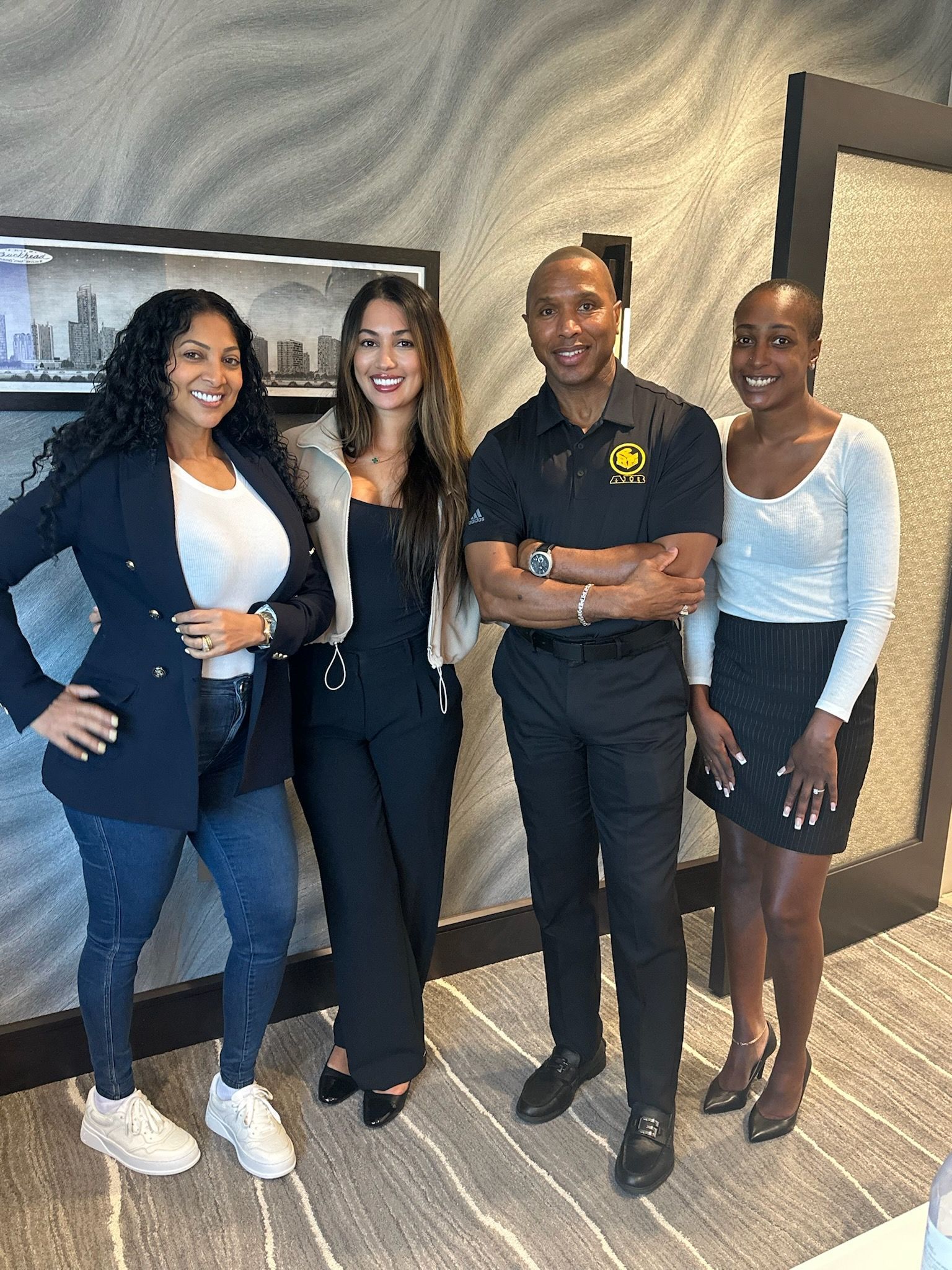 A group of people are posing for a picture together in a room.