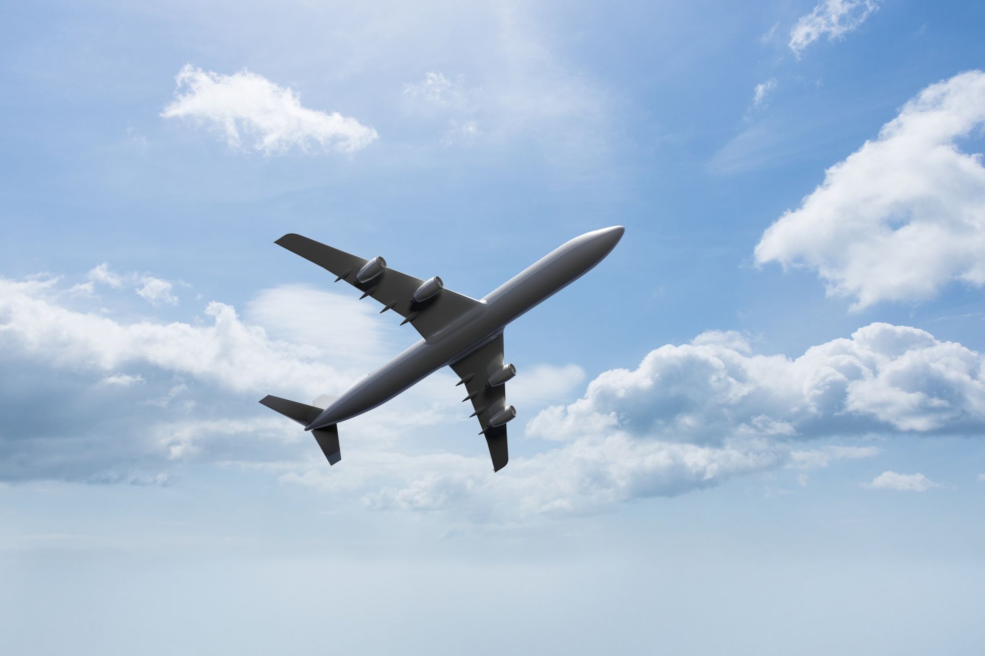 A large passenger jet is flying through a cloudy blue sky.