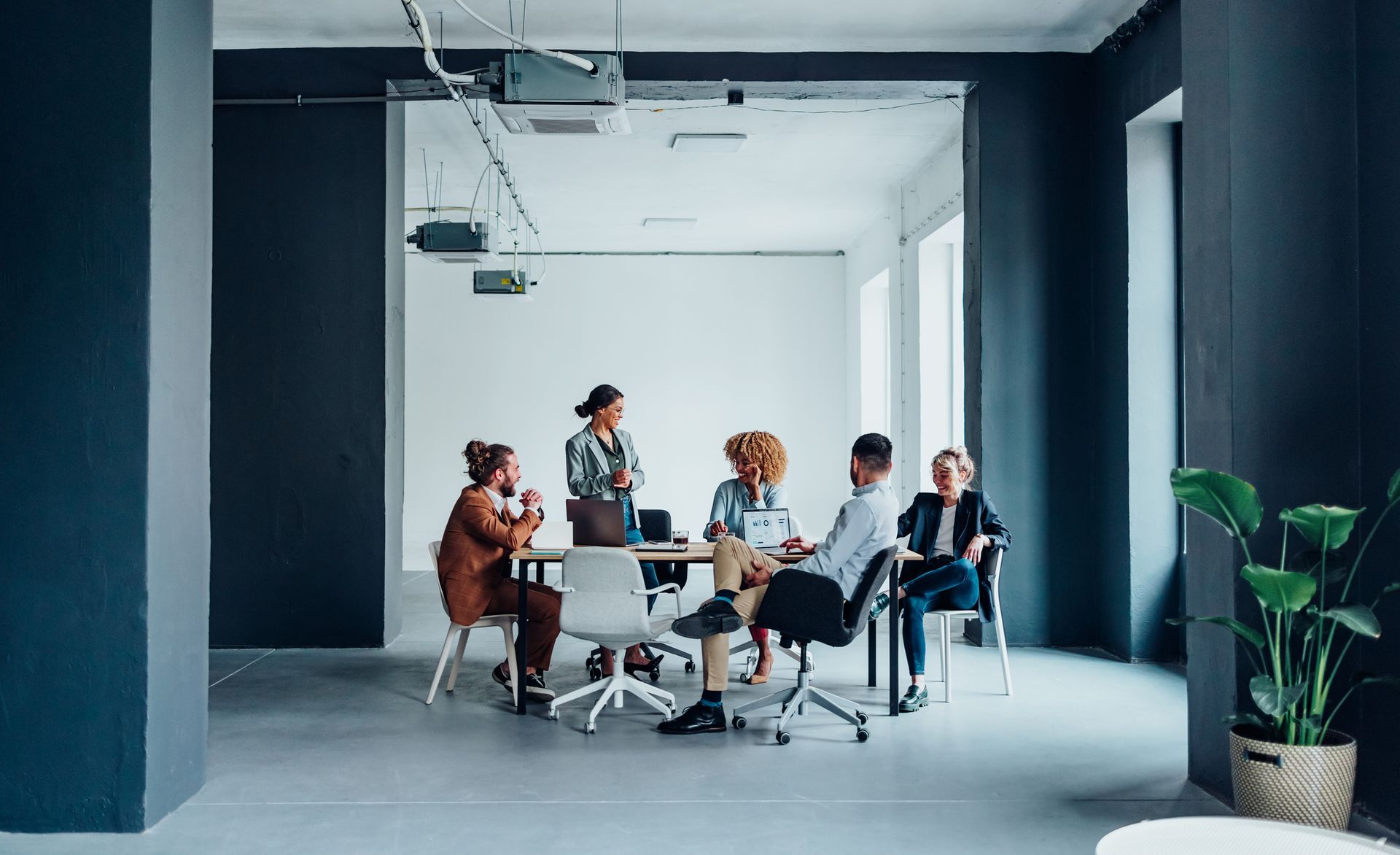 A group of people are having a meeting in a conference room.