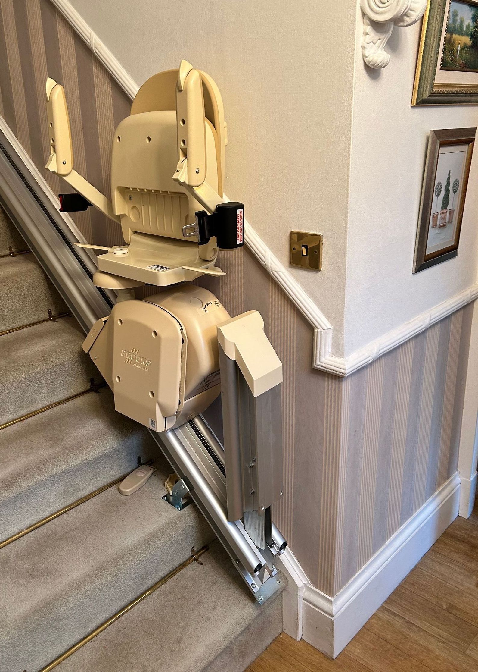 Hinged stairlift rail to clear door threshold or passageway.