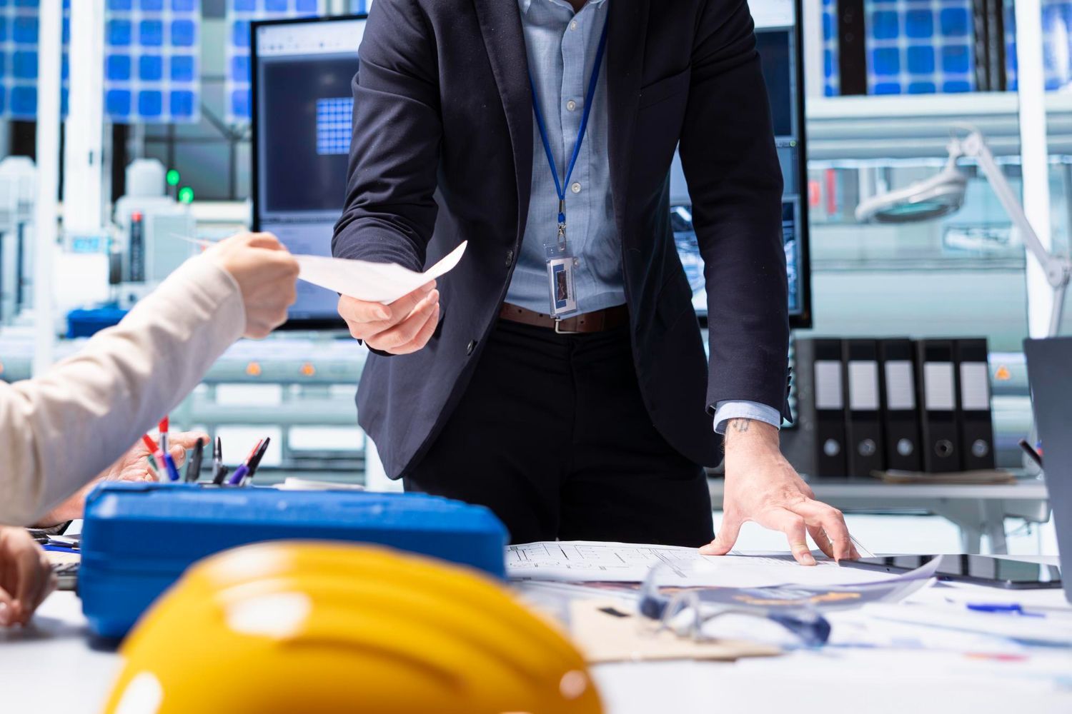An aerial view of a man pushing a pallet truck in a warehouse.