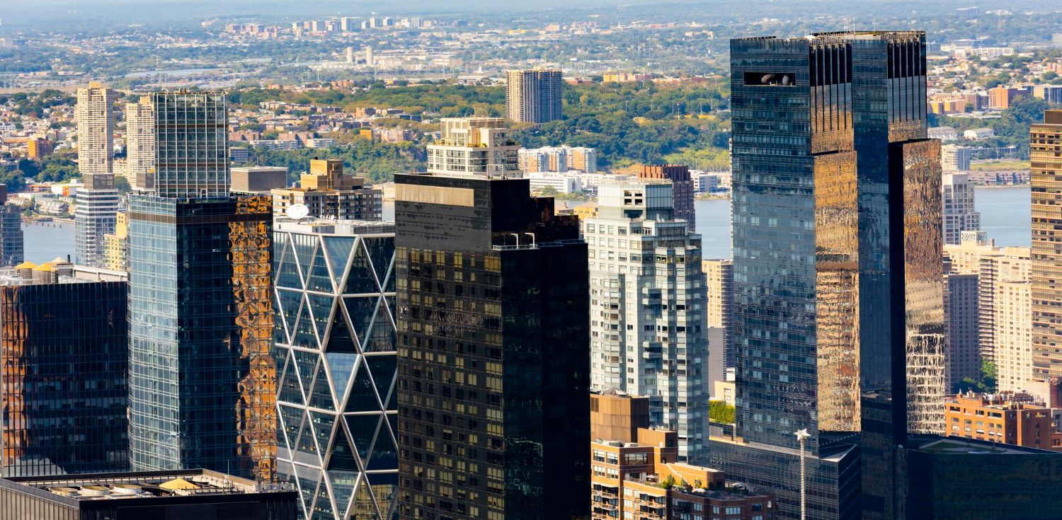 A family is getting into a car in front of a house.