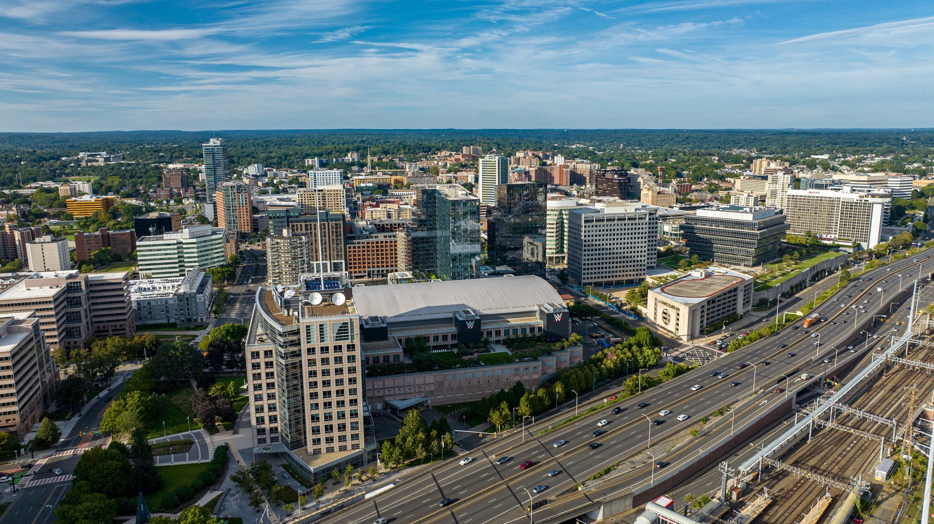 An aerial view of a city with a highway and lots of buildings.
