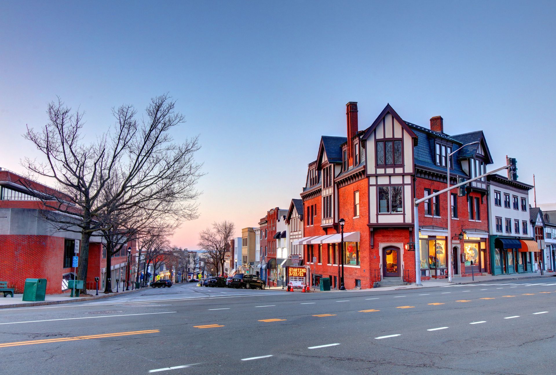 A row of buildings are lined up on the side of a city street.