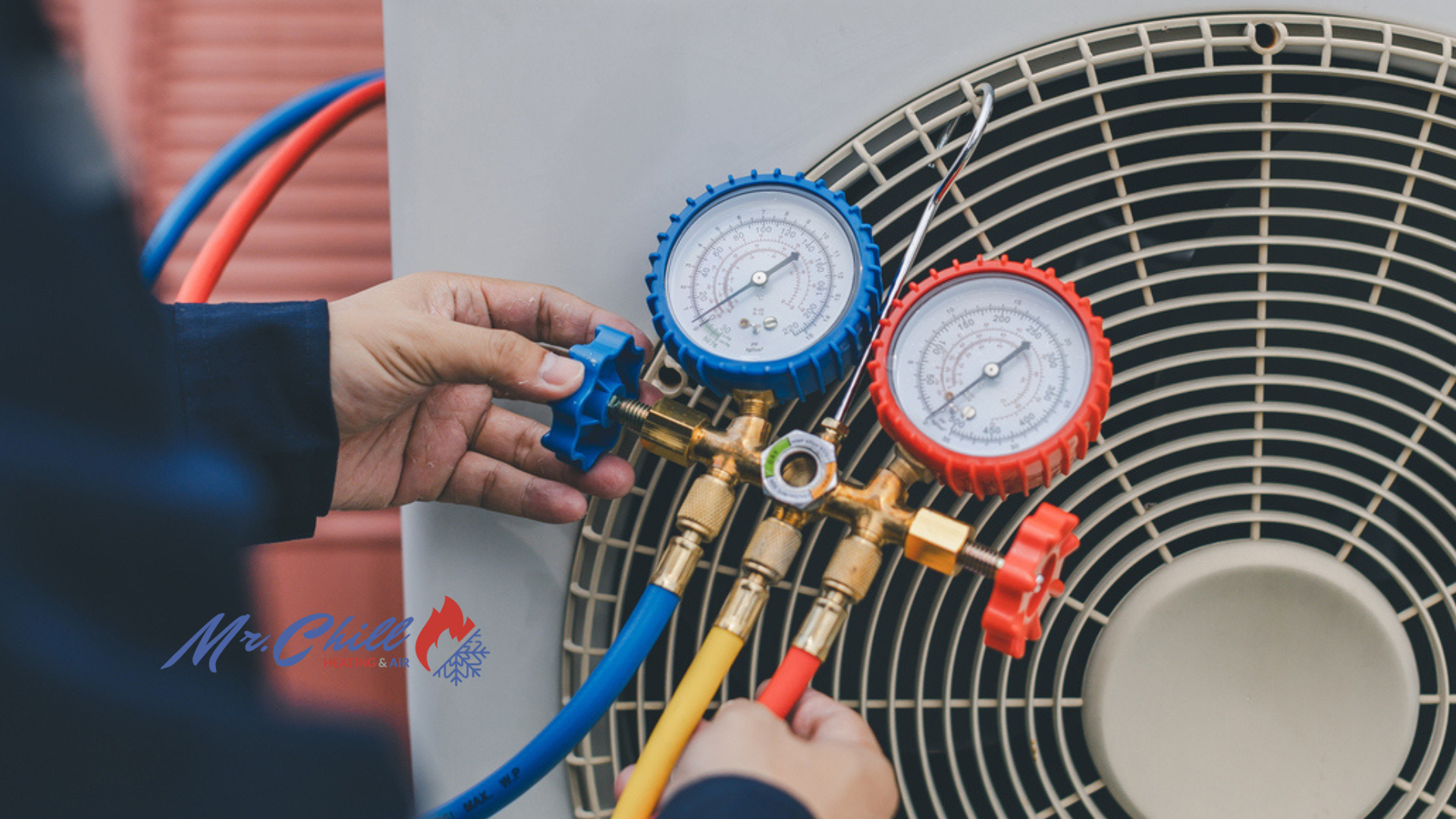 Technician adjusting HVAC manifold gauges beside an outdoor air conditioner unit