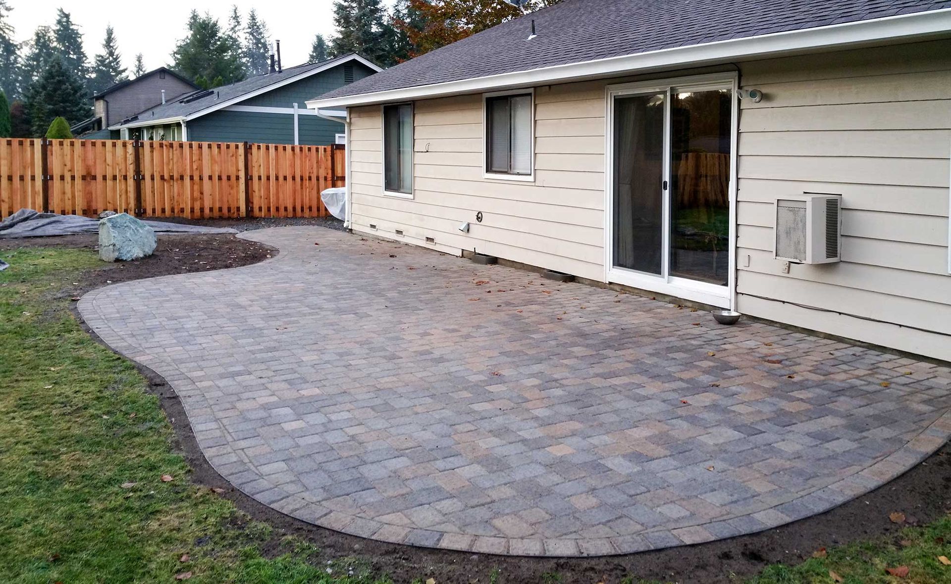 An empty brick-paved patio with neatly arranged bricks and no furniture or decorations.