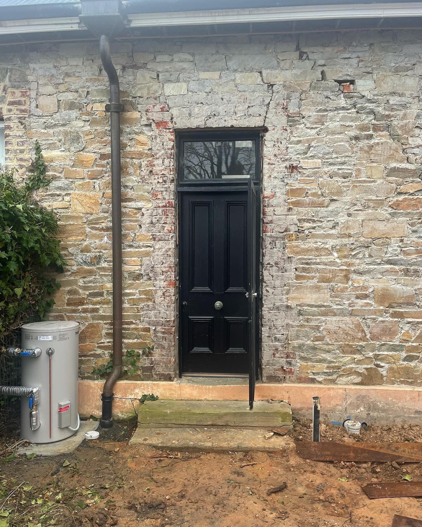 Black Door Set in Stone Building — Demetrius Projects in Queanbeyan East, NSW