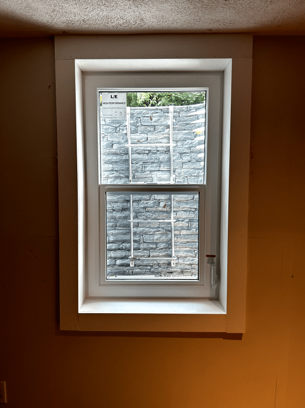 A window in a room with a brick wall behind it