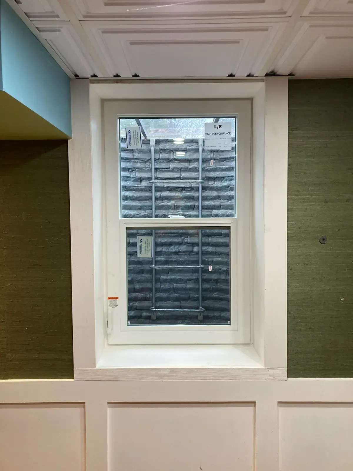 A window in a room with green and blue walls