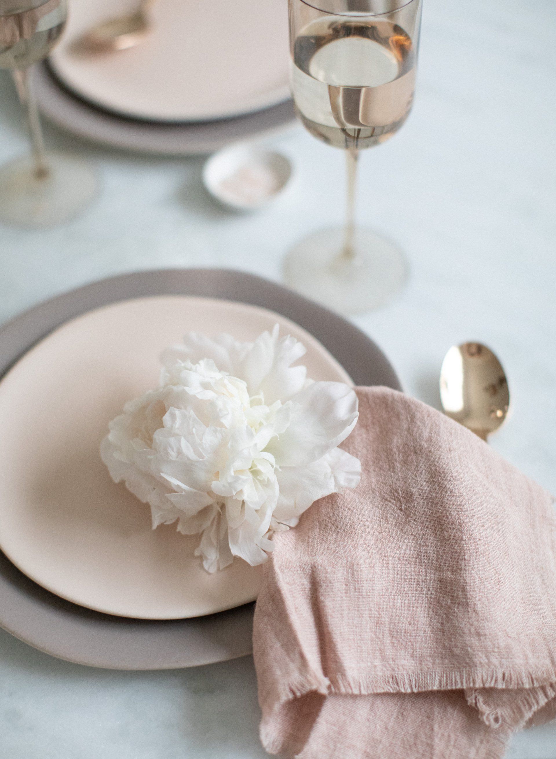 A close up of a plate with a flower on it on a table.