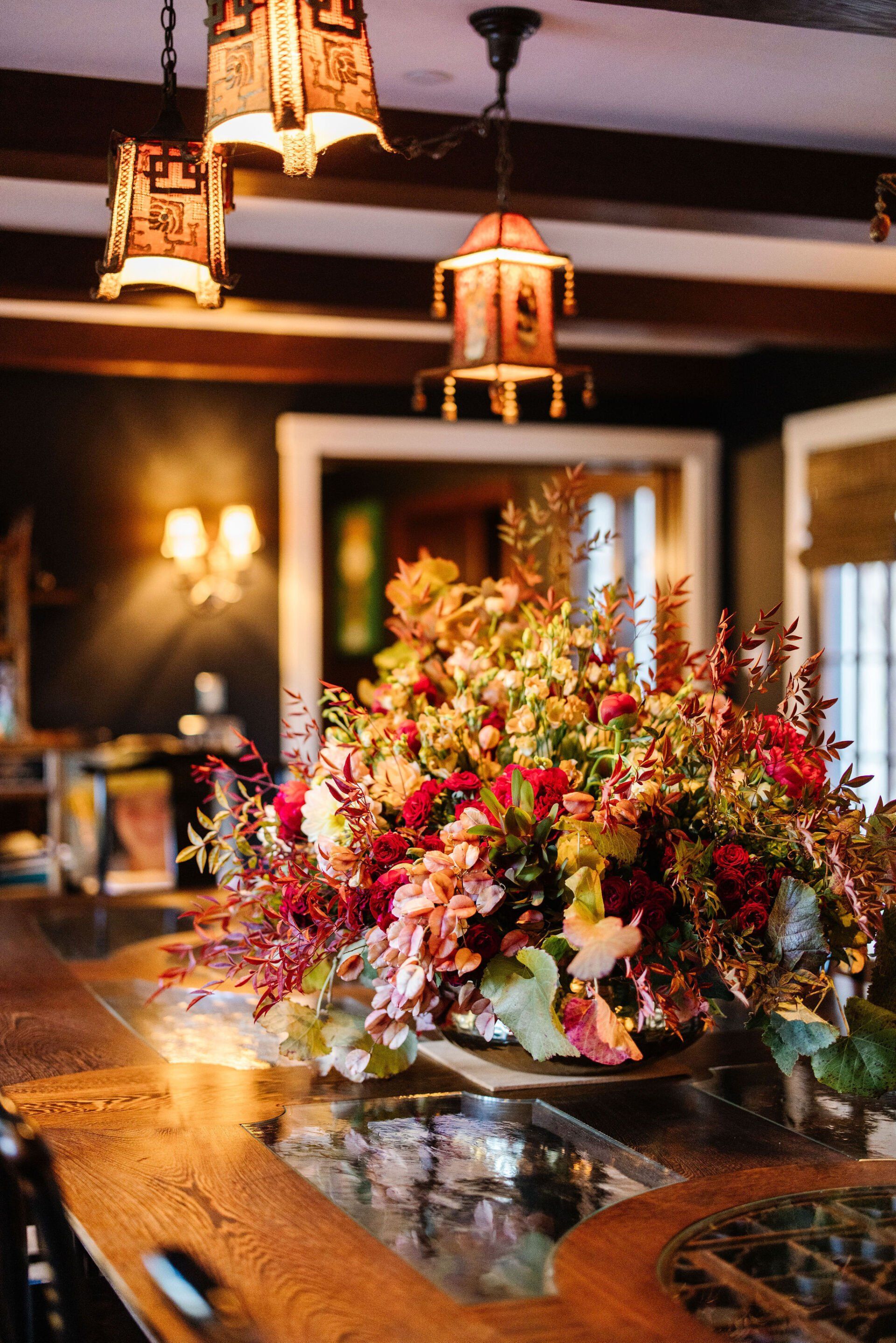 A table with a vase of flowers on it in a room.