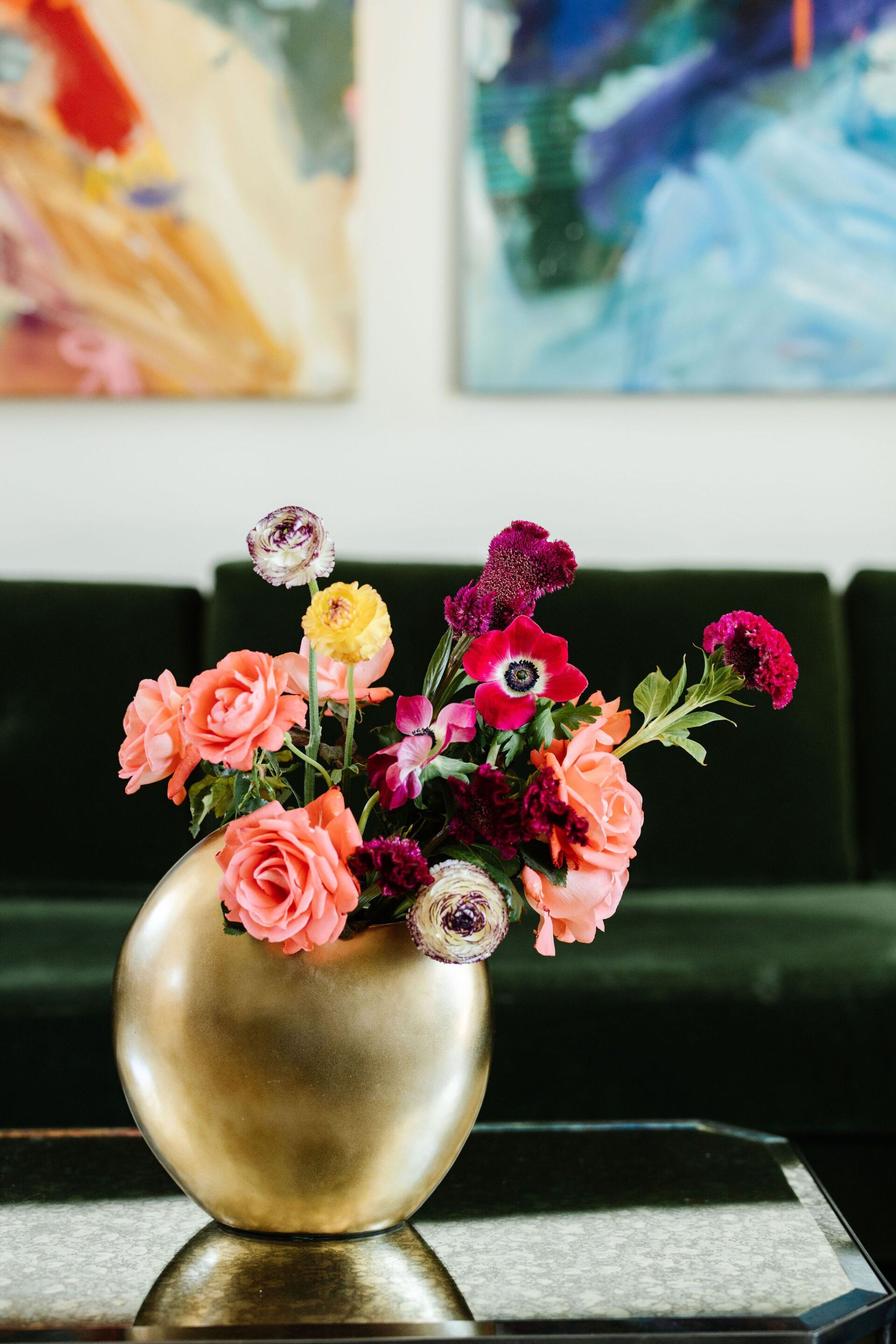 A vase filled with flowers is sitting on a table in a living room.