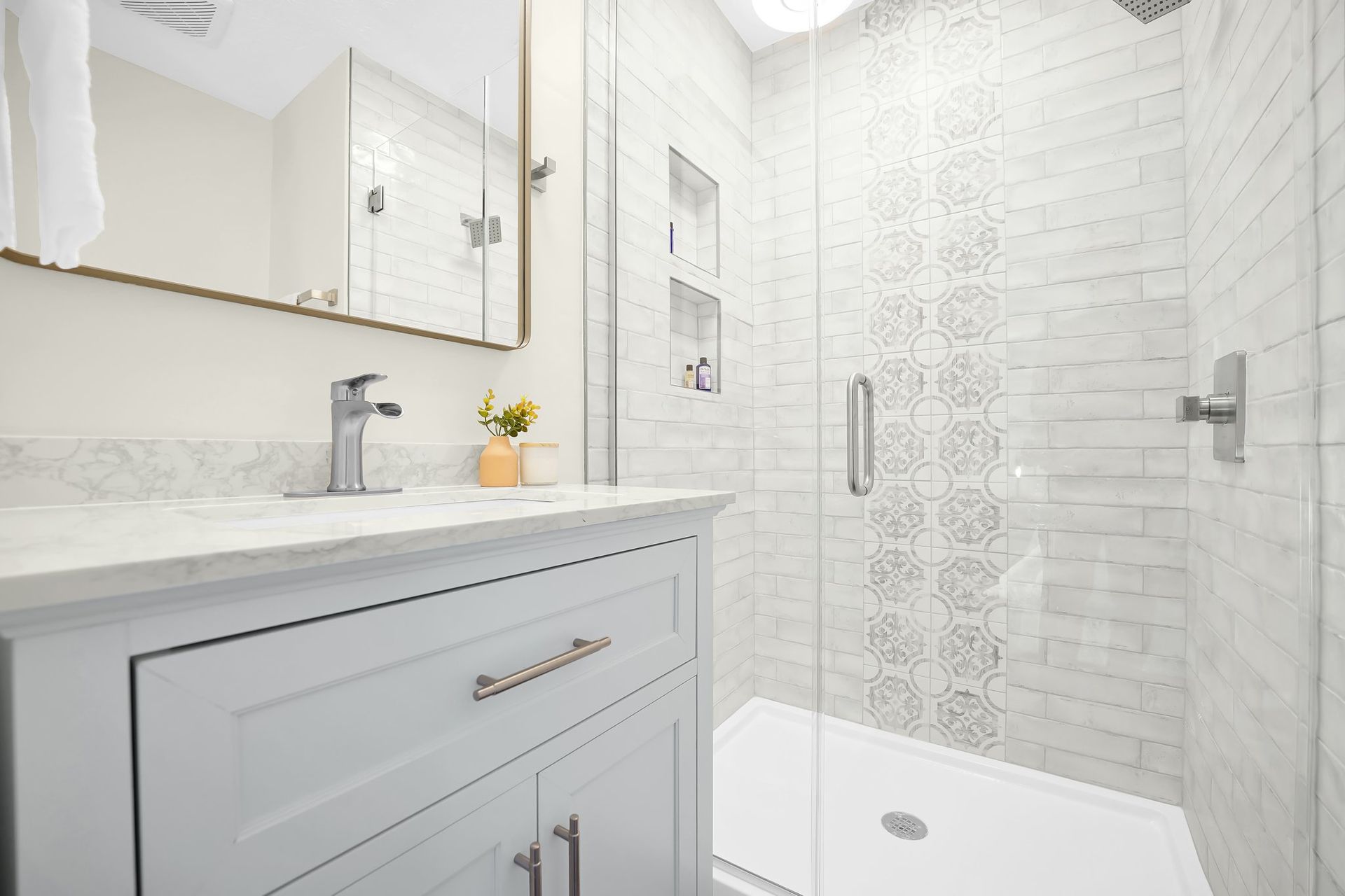 A living room with a staircase and a flat screen tv.