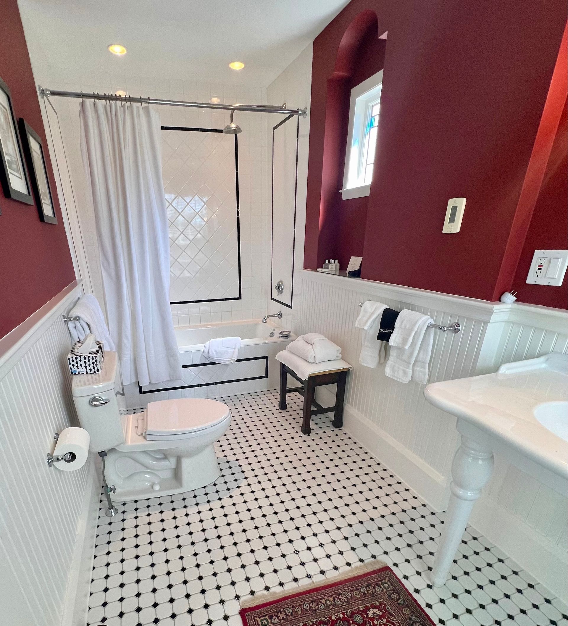 A bathroom with a toilet a sink and a bathtub