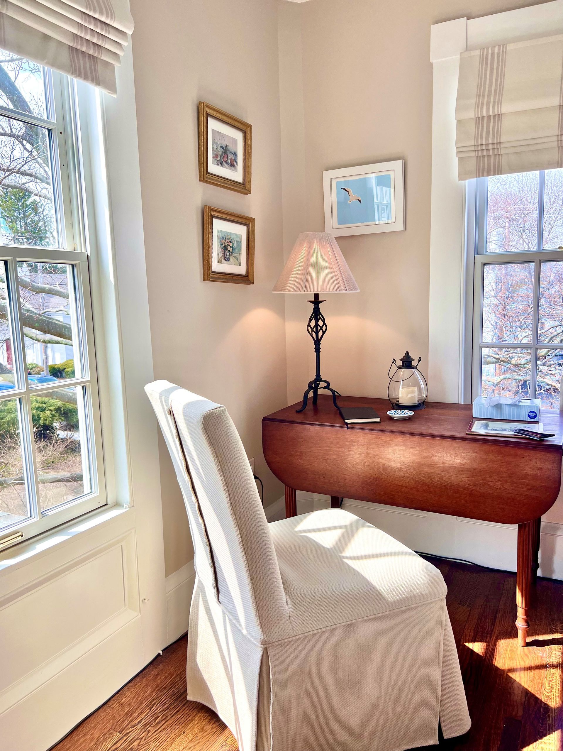 There is a desk and chair in the corner of the room.