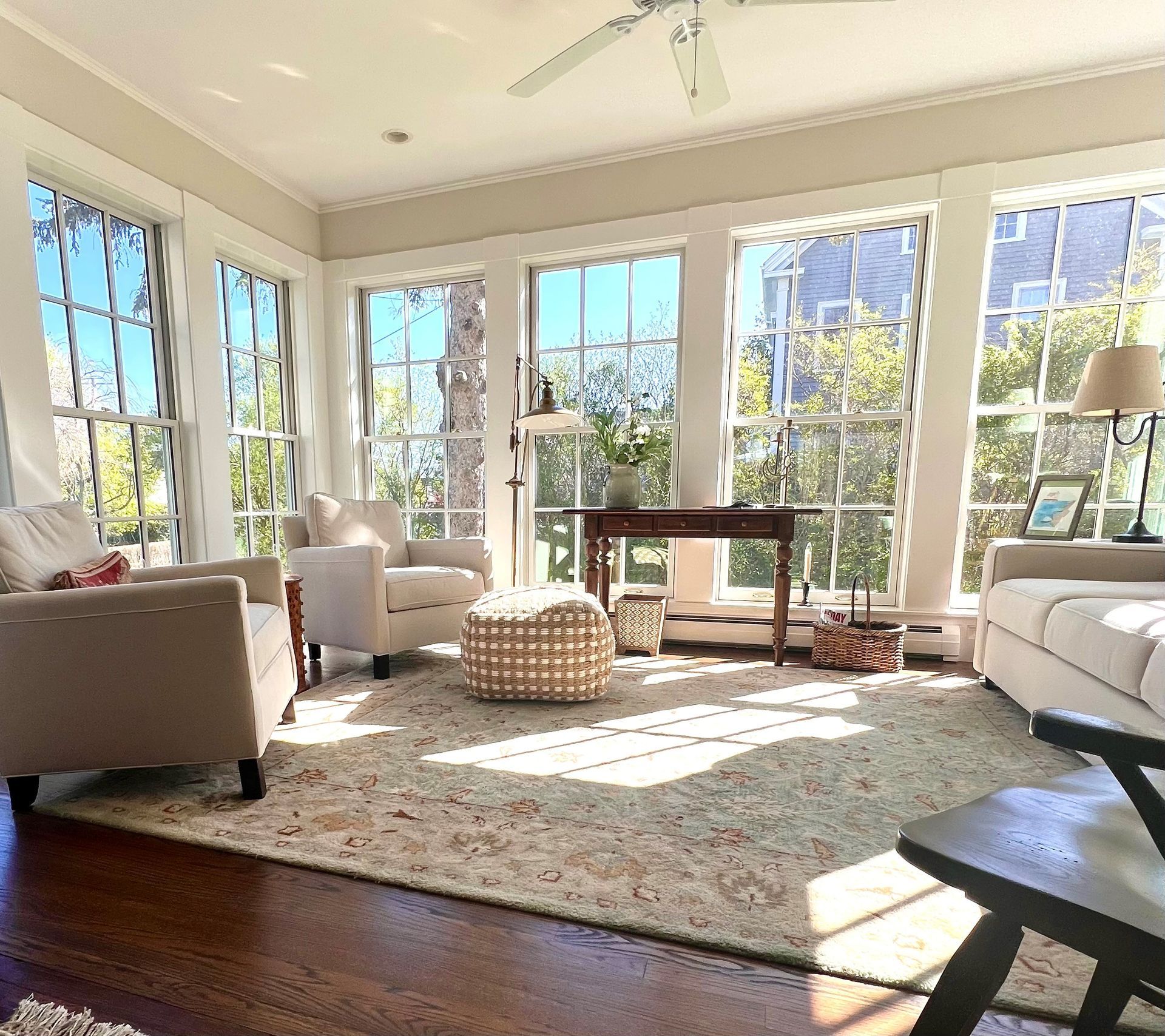 A living room with a lot of windows and furniture
