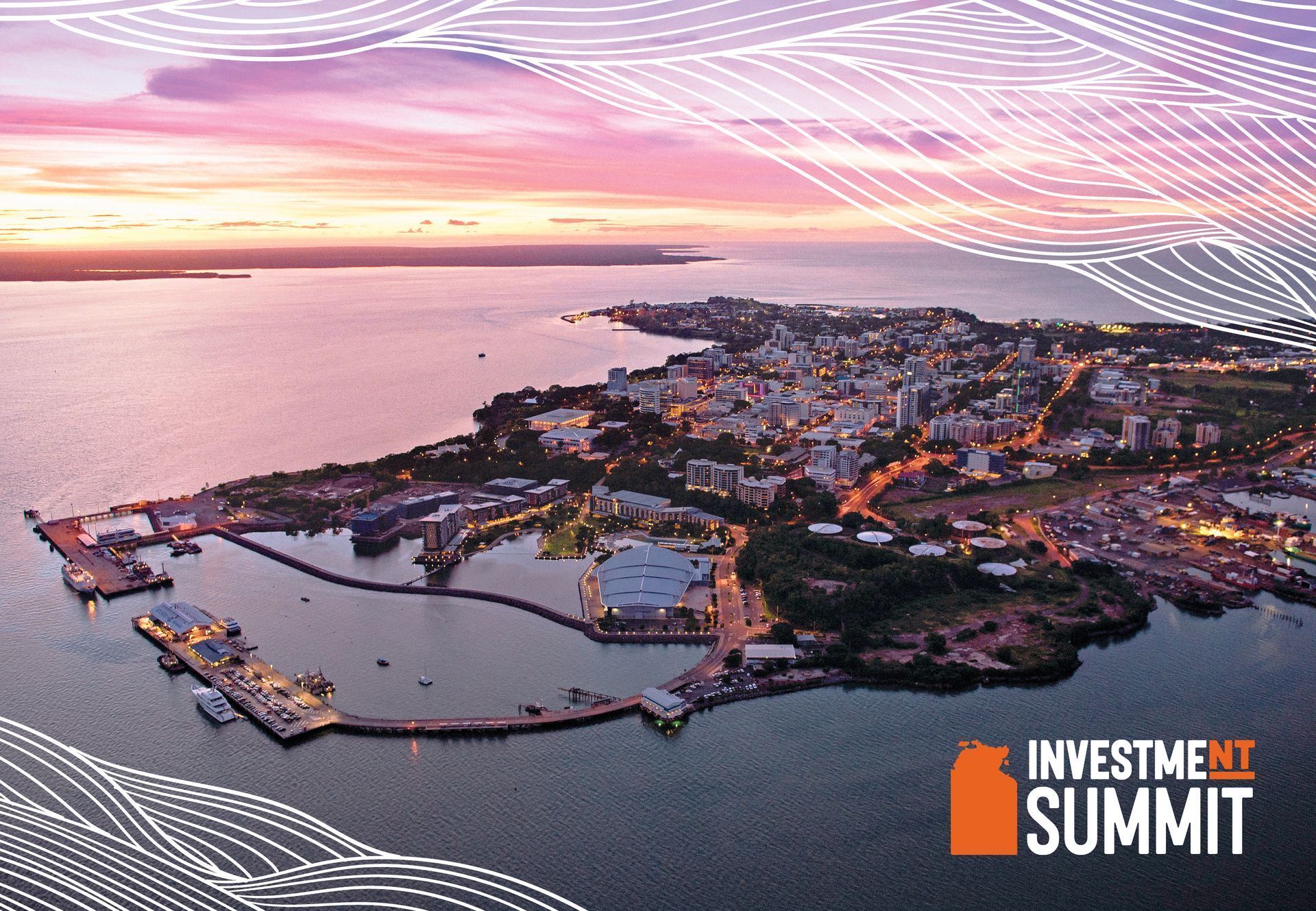 Aerial view of Darwin, Australia at sunset, featuring the city waterfront and harbor, with an Investment Summit logo.