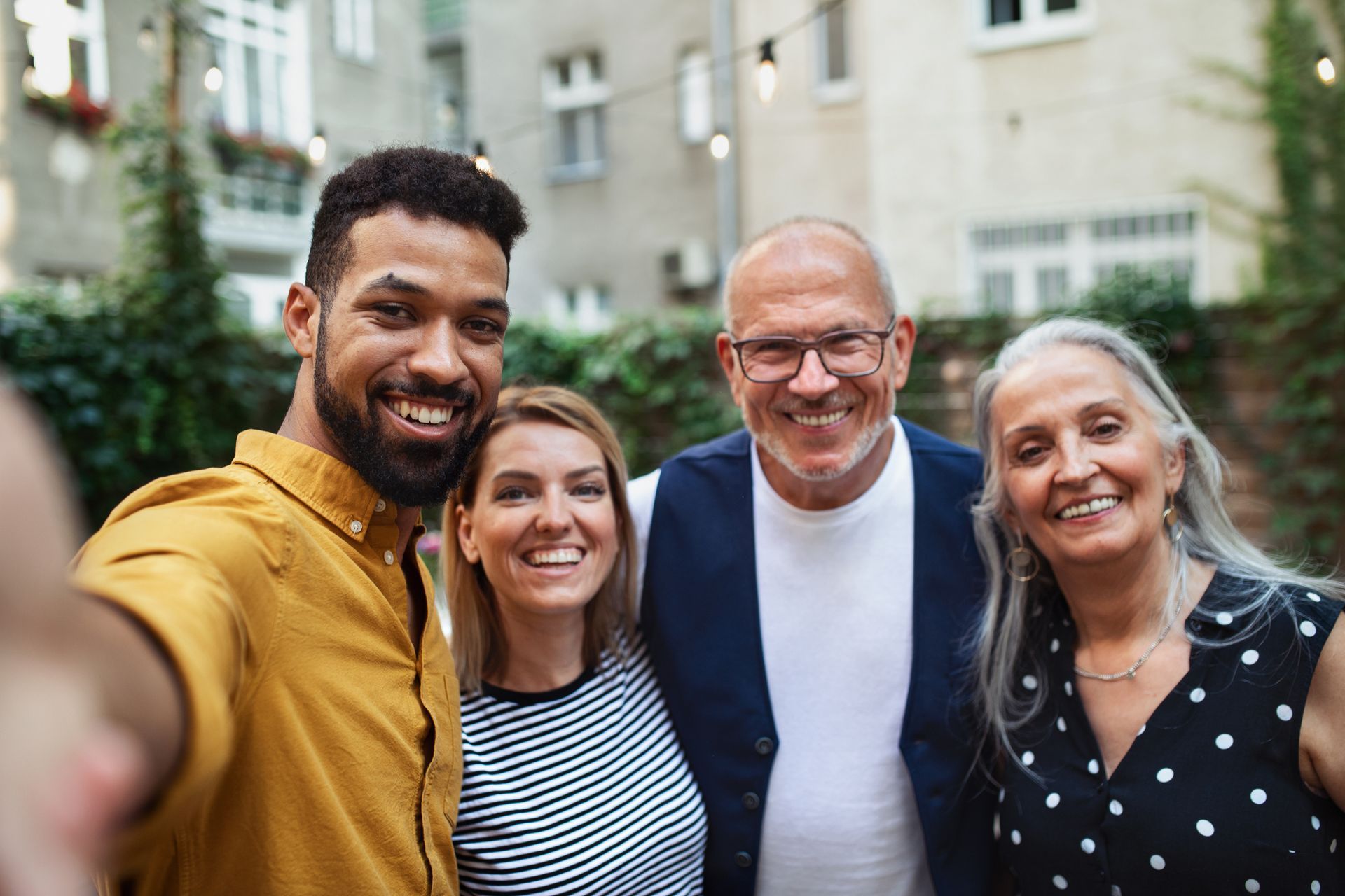 a man is taking a selfie with his family .
