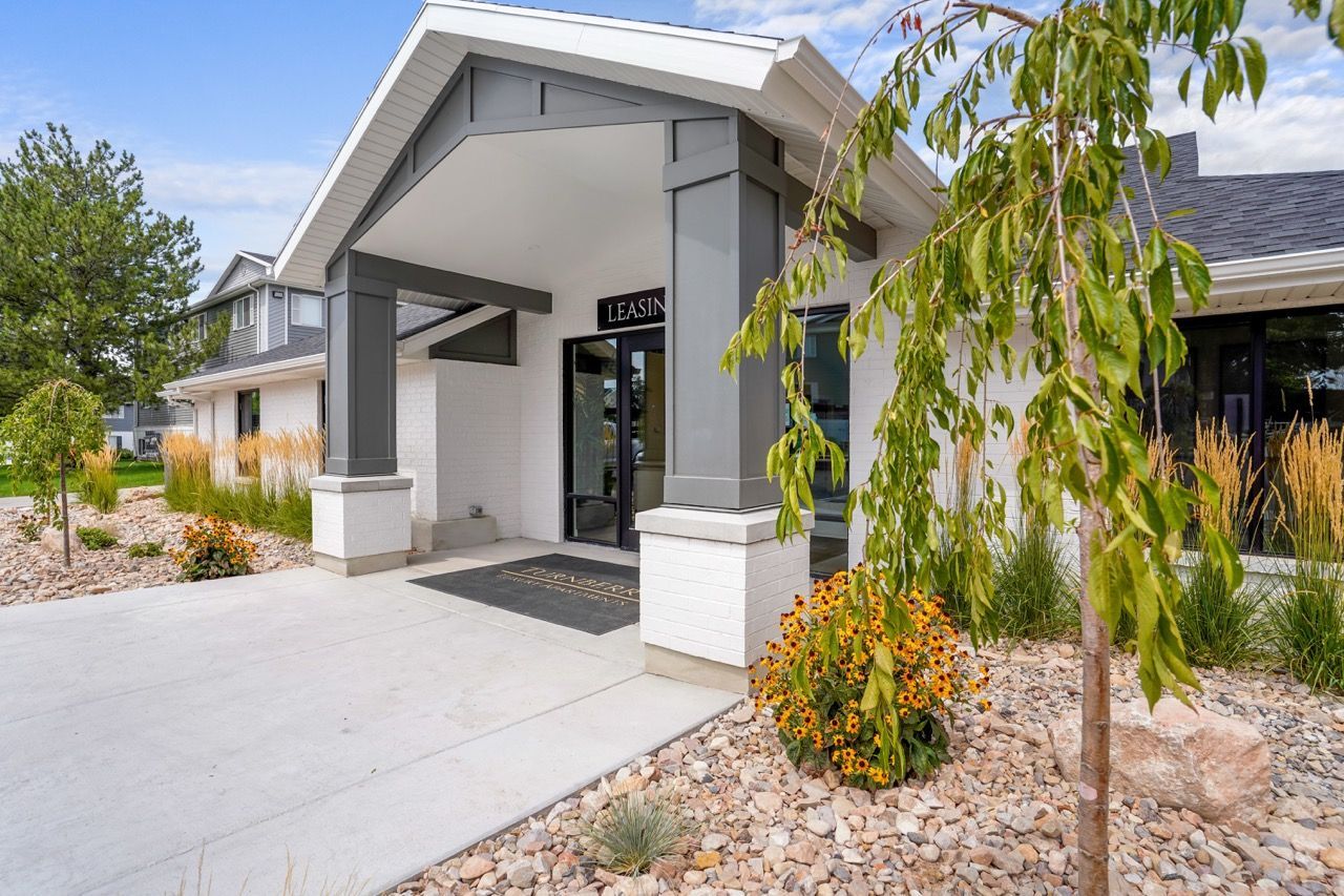 Exterior entrance to the apartment community with a leasing sign and landscaped beds. Schedule a tour at Turnberry Apartments and explore comfortable apartments in Millcreek, UT, designed for everyday living.
