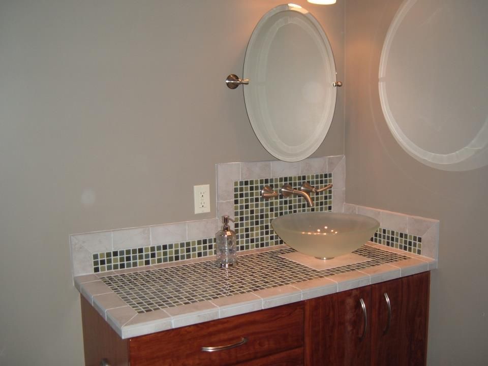 A bathroom with two mirrors and a sink