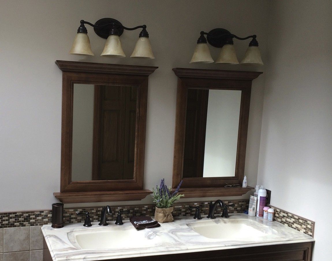 A bathroom with two sinks and two mirrors