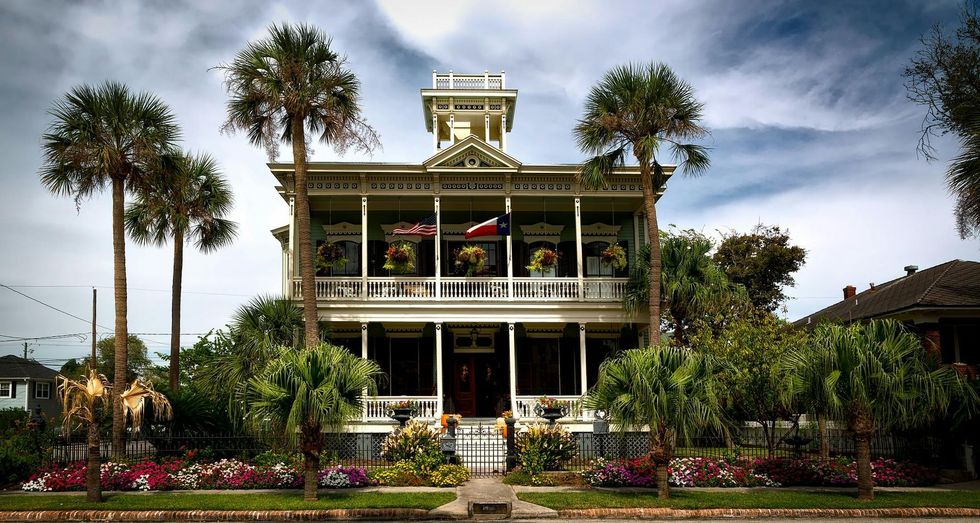 A large house with palm trees in front of it