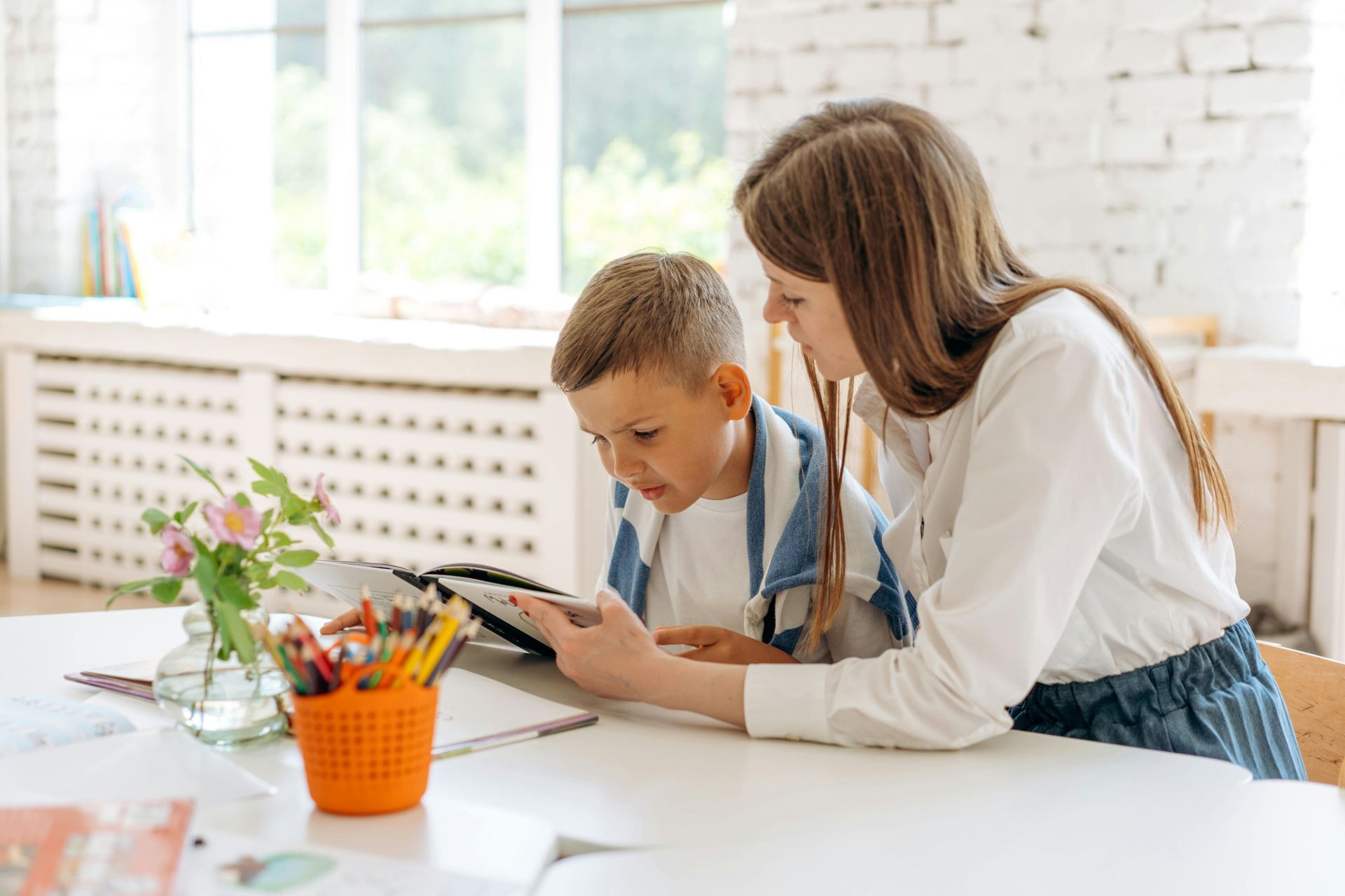 a Woman and a Boy Are Sitting at a Table Looking at a Tablet — RIP IT UP Reading in Maitland, NSW
