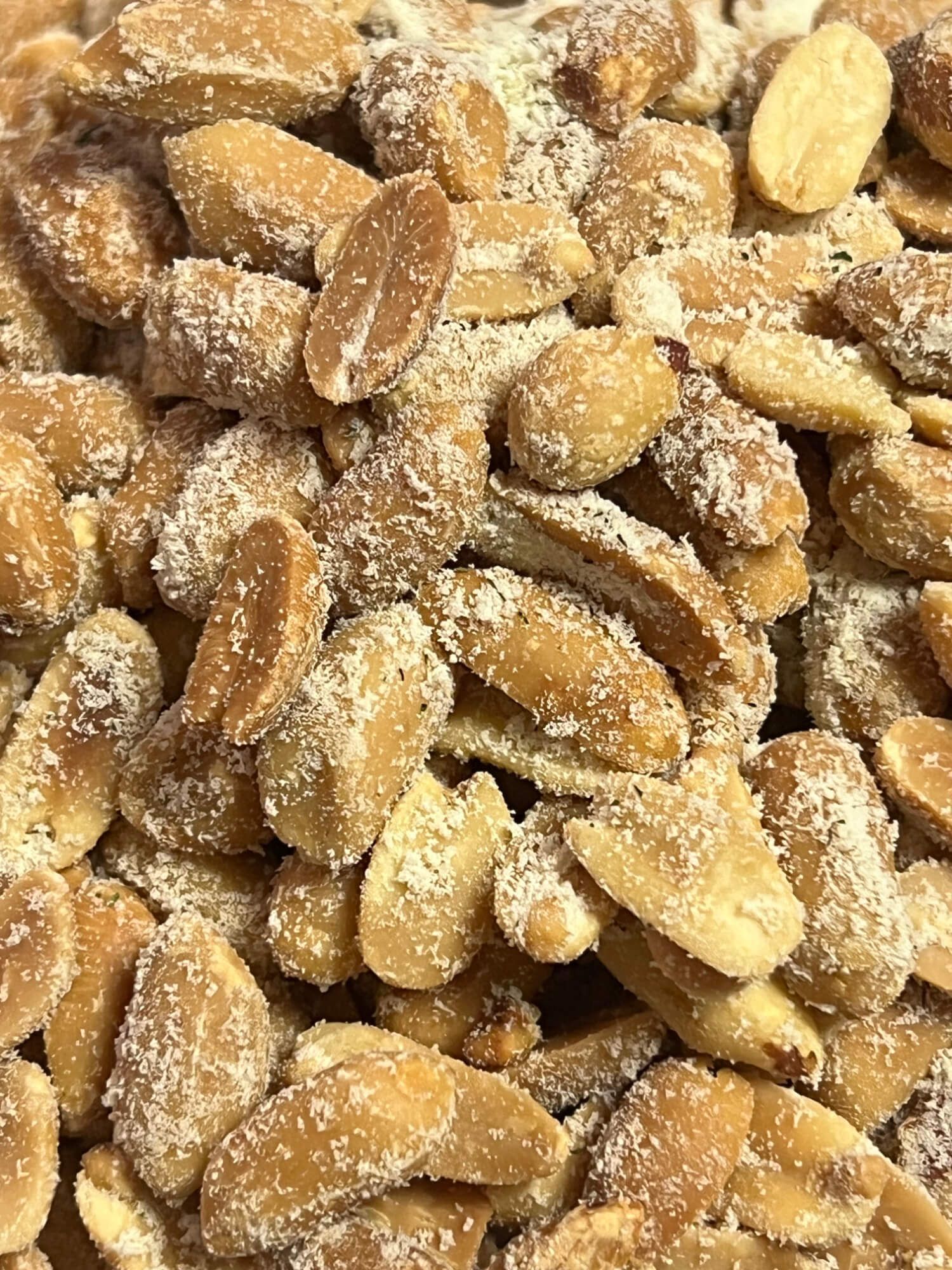 A pile of peanuts covered in sugar on a table.