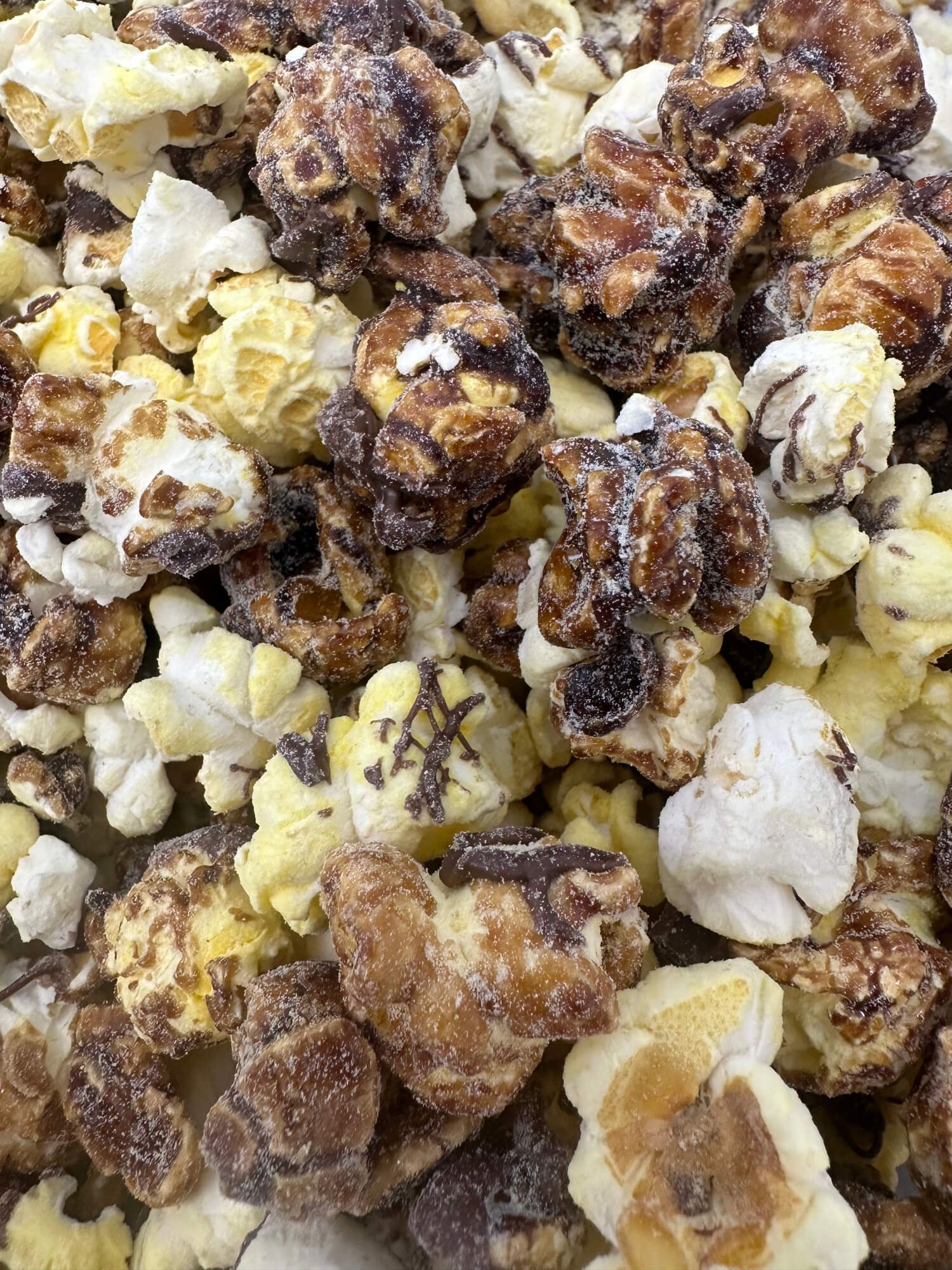 A close up of a pile of chocolate covered popcorn.
