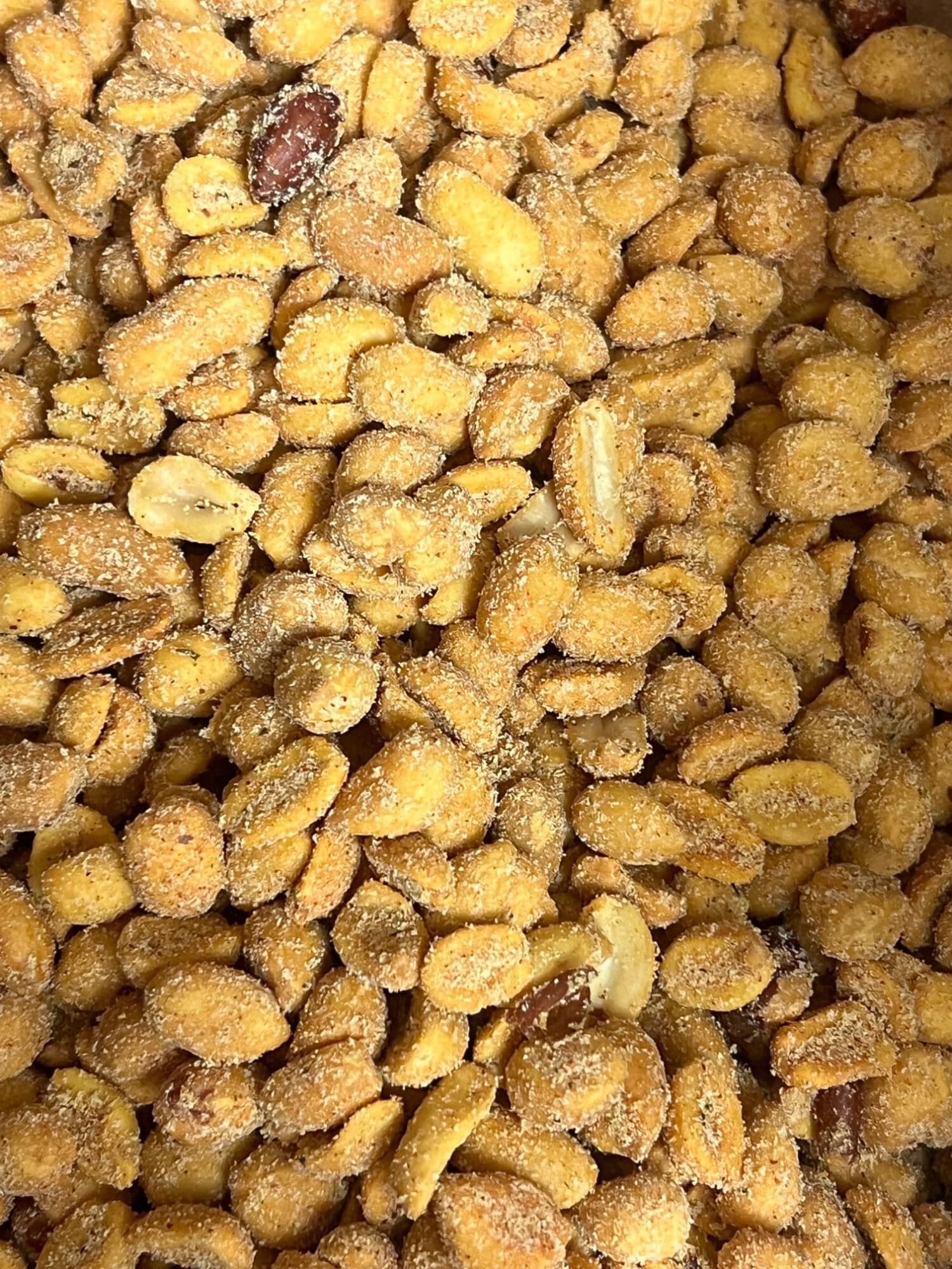 A close up of a pile of peanuts covered in sugar.