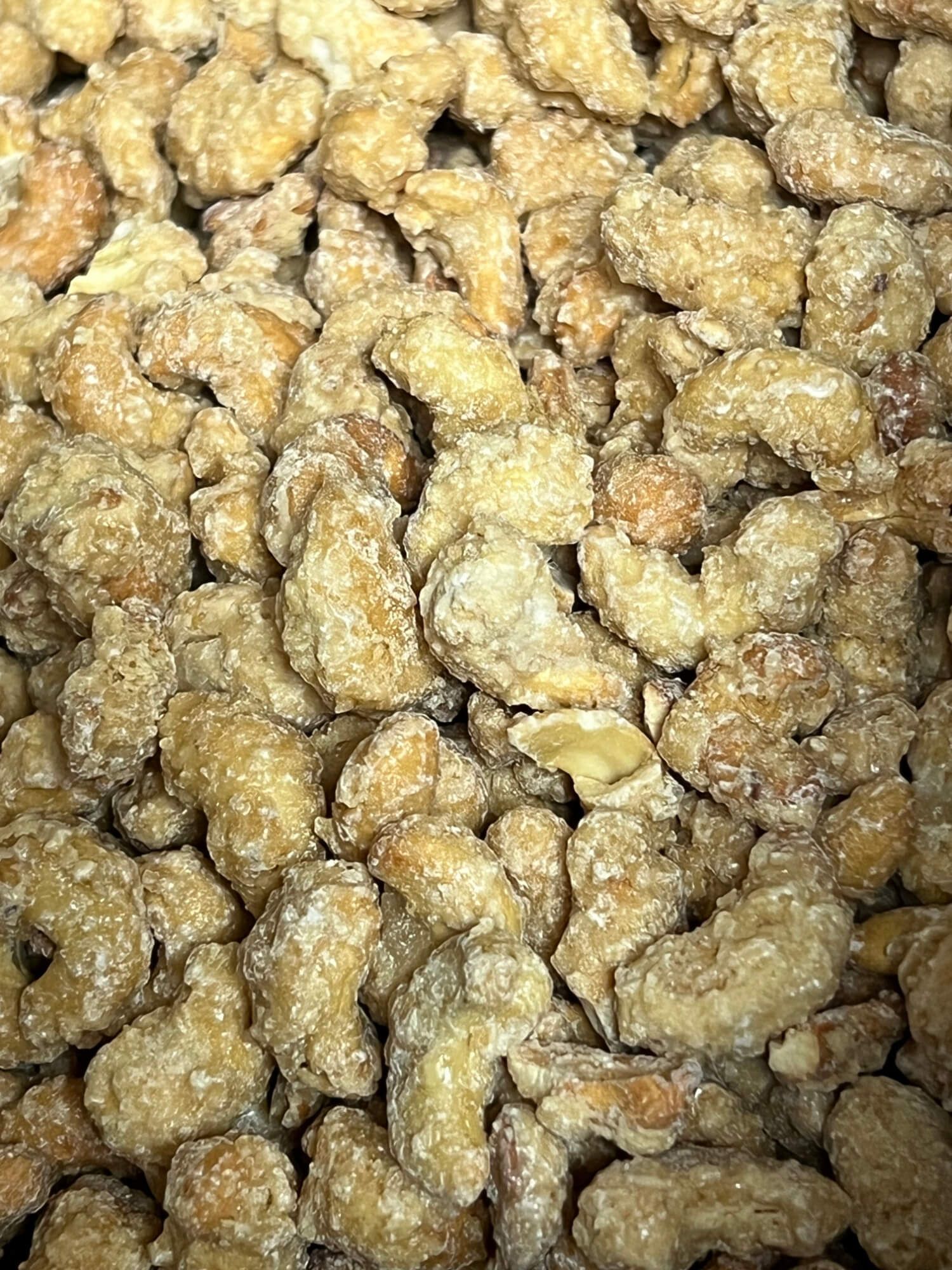 A close up of a pile of caramelized walnuts.