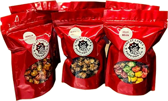 Various gourmet popcorn in red bags from Great Lakes Popcorn Co. that are perfect for fundraising activities.