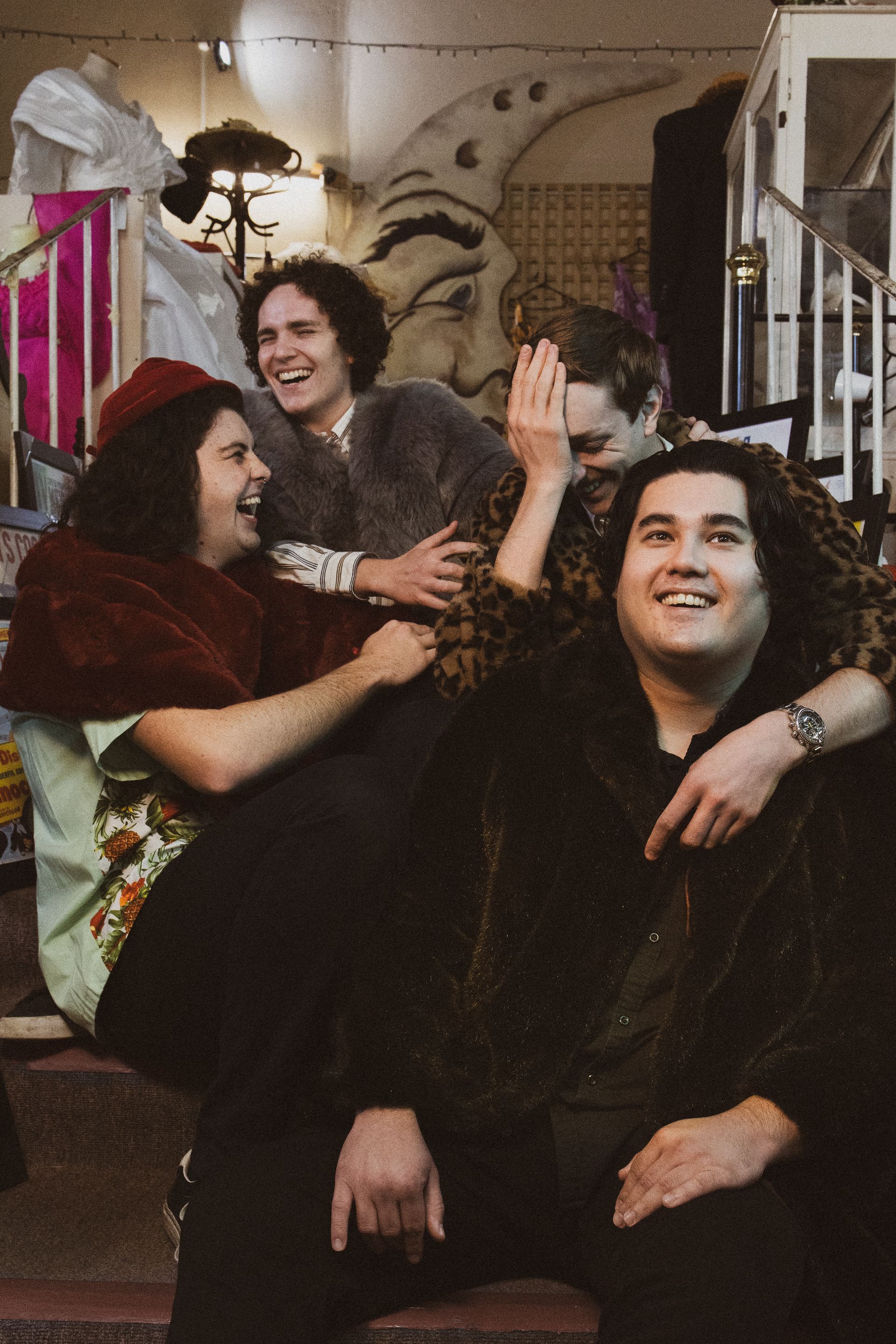 A group of people are posing for a picture and laughing